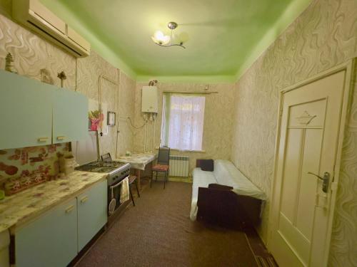 a kitchen with a sink and a stove top oven at NunSon Guest House in Yerevan