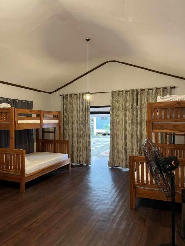 a bedroom with two bunk beds and a window at Villa Bella 3 Beach Resort in Buyog