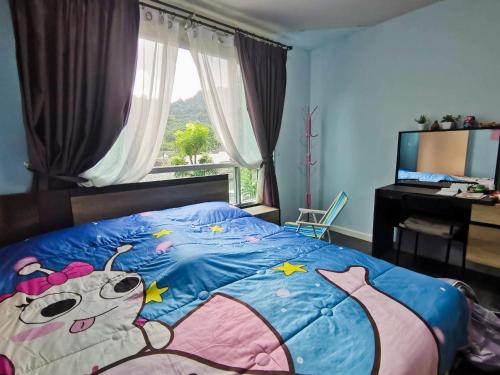 a bedroom with a large bed with a hello kitty blanket at Valley Mountain View&City Proximity Golden Eight Apartment in Ban Phlu Yai