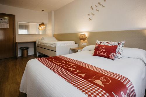 Una cama o camas en una habitación de Hotel Catalunya Ribes de Freser