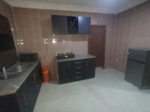 a kitchen with a sink and a counter top at GA guest House in Ibadan