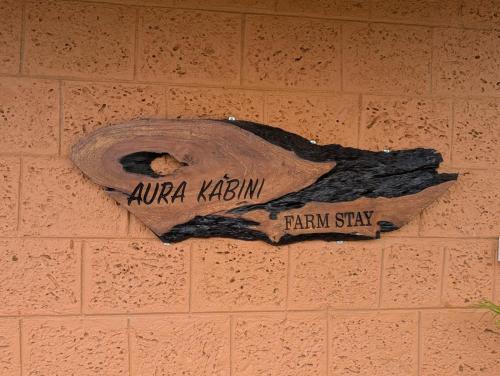 a sign on the side of a brick wall at Aura Kabini by Tripture in Begūr