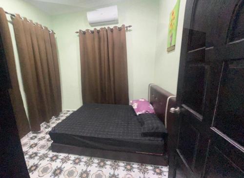 a bedroom with a bed in a room at Inara Homestay in Kepala Batas