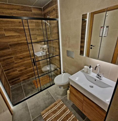 a bathroom with a shower and a sink and a toilet at 2 Bedroom Cozy Apartment in Antalya
