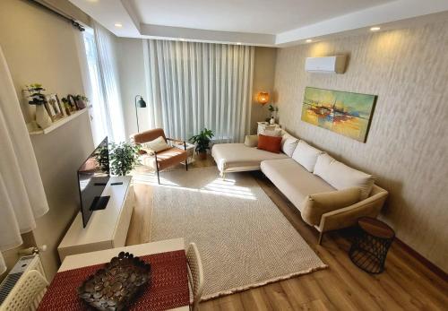 a living room with a couch and chairs in a room at 2 Bedroom Cozy Apartment in Antalya