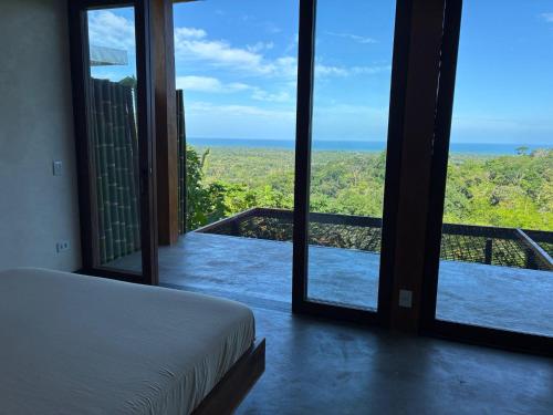 una camera da letto con un letto e vista sull'oceano di Fazenda 101 a Ilhéus