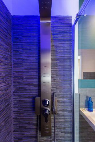 a shower in a bathroom with a glass door at Politeama Luxury Suites in Palermo