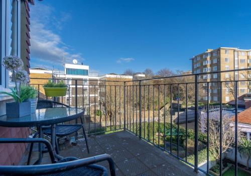 a balcony with a table and a fence at Brunswick Fab Pad By My Getaways in Brighton & Hove