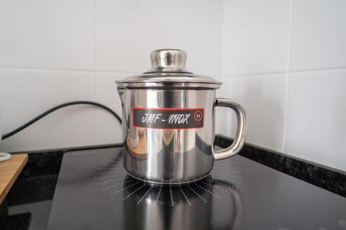 a coffee pot sitting on top of a stove at GREEN STUDIO - Apt 003 Aconchegante e Moderno in Tarrafal