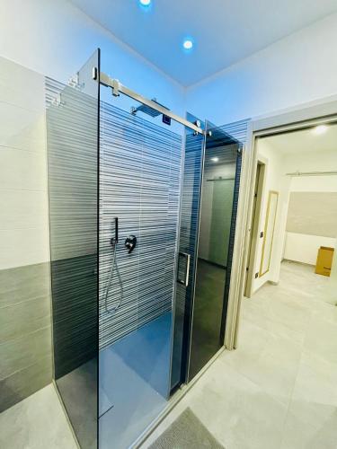 a shower in a bathroom with a glass door at Milano Bicocca Apartment & Rooms2 in Cinisello Balsamo