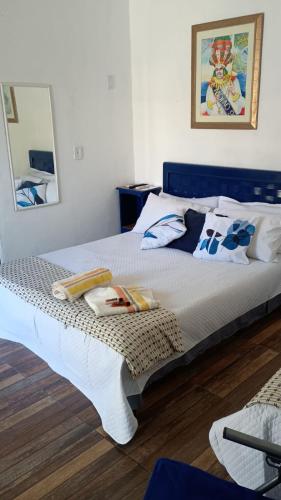 a bedroom with a large white bed in a room at Hostel Suite Home in Saquarema