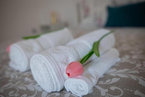 um conjunto de toalhas enroladas com uma flor rosa sobre uma mesa em spot do vale em Machico