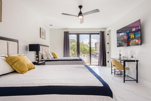 劳德代尔堡Luxury Paradise walk to Las Olas -5 mins to Beach的有两张床和一扇窗户的酒店房间