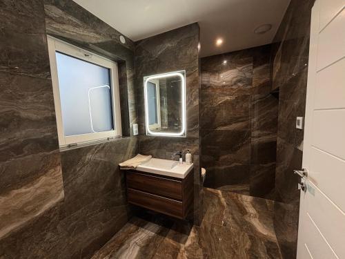 a bathroom with a sink and a mirror at Le Cube Strasbourg - Marlenheim in Marlenheim