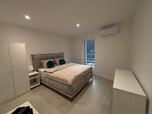 a bedroom with a bed and a large window at Le Cube Strasbourg - Marlenheim in Marlenheim