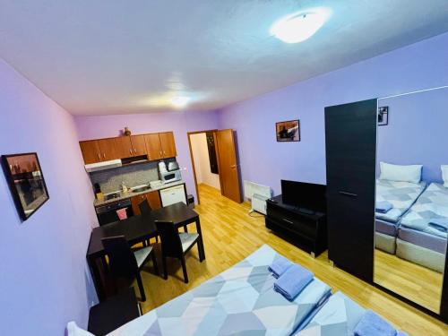 a living room with a kitchen and a dining room at Predela 1 - Studio 10 near Bansko Ski Lift in Bansko