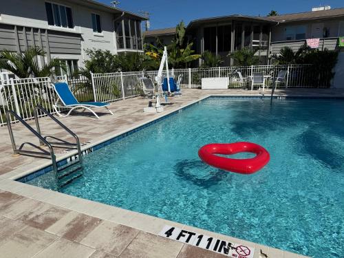 a pool with a red heart in the water at Southside Village Resort Apartments by Lucky Vacation Homes in Sarasota