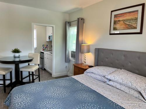 a bedroom with a bed and a table and a kitchen at Southside Village Resort Apartments by Lucky Vacation Homes in Sarasota