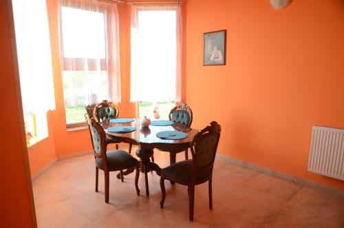 a dining room with a table and four chairs at Penzion Folbr in Dlouhá Lhota