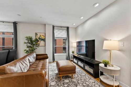 a living room with a couch and a piano at Beautiful 2BR in Southend Boston in Boston