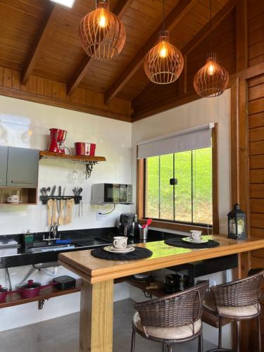 a kitchen with a large wooden table and chairs at Sítio Rancho Mineiro in Domingos Martins