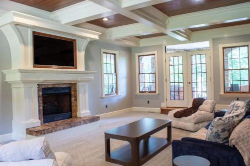 a living room with a fireplace and a flat screen tv at Creekside Haven with Dock & Scenic Views in Hollywood