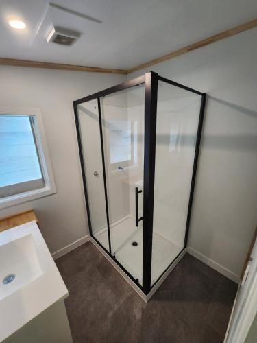 a glass shower in a room with a window at Ohakune Getaway in Ohakune