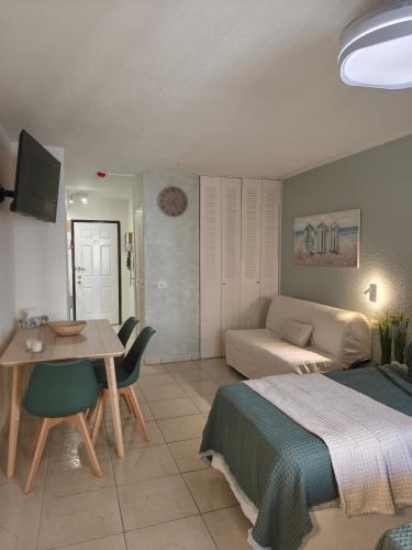 a bedroom with a bed and a table and a couch at Dreams Castle in Los Cristianos