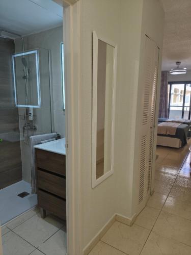 a bathroom with a shower and a sink and a mirror at Dreams Castle in Los Cristianos