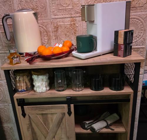a shelf with a coffee maker and oranges on it at Olive Ultracentral Craiova in Craiova