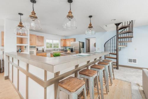 a kitchen with a large island with bar stools at Sunset Shores in Pacific City