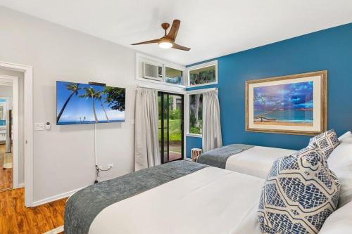 a bedroom with two beds and a ceiling fan at Kapalua Ridge Villas 1414 · KRV 1414 Remodeled 2BD Kapalua Vill in Kahana