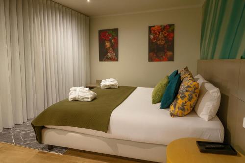 a bedroom with a bed with towels on it at BE ONE HOTEL Caldas da Rainha - by MHMB Hospitality in Caldas da Rainha