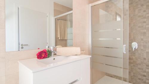 a white bathroom with a sink and a mirror at Can Colomer Ferragut in Artá