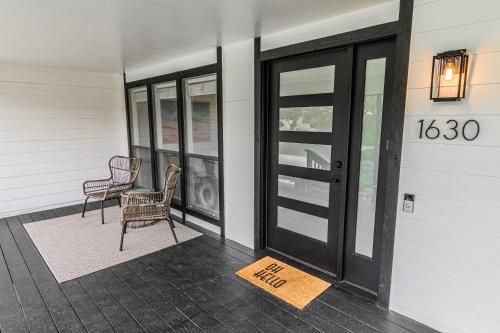 a porch with a sign that says on it at Cozy Cove Cottage in Seaside