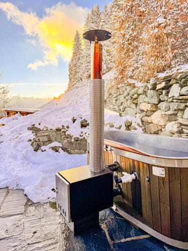 a small stove is on a deck in the snow at Le Raidillon Verbier in Verbier