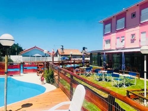 a building with a swimming pool next to a building at hotel los ACANTILADOS in Mar del Plata