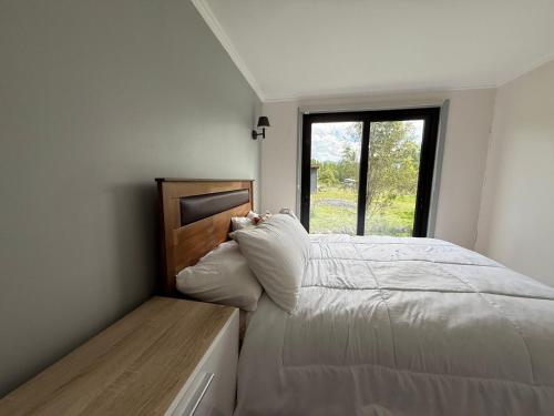 Ένα ή περισσότερα κρεβάτια σε δωμάτιο στο Cabaña Rapha