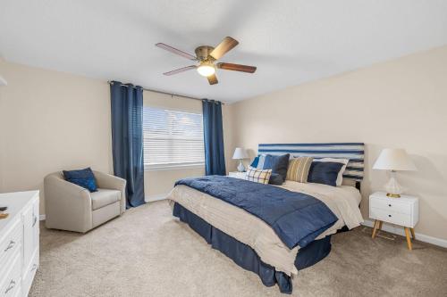 a bedroom with a bed and a ceiling fan at Launch and Lounge Cozy Cape Canaveral Beach Townhome Near Surf and Space in Cape Canaveral