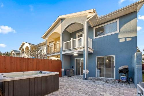 a house with a hot tub in a yard at Stylish Townhome w Hot Tub 5 Min Walk to Beach in Cape Canaveral