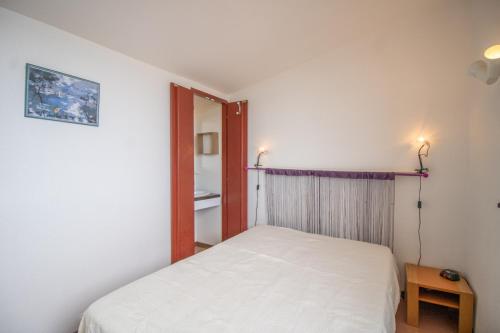 Ένα ή περισσότερα κρεβάτια σε δωμάτιο στο Location Porticcio