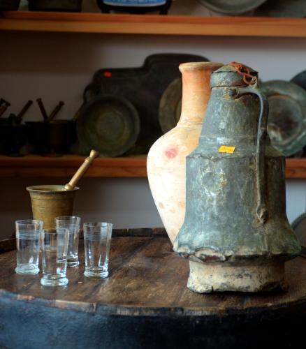 an old jug sitting on a table with glasses at Kemerli Konak Boutique Hotel in Kérynia