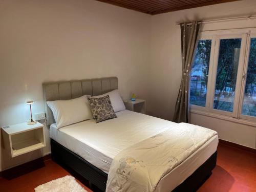 a bedroom with a bed and a window at Casa bulgara boutique in Aristóbulo del Valle