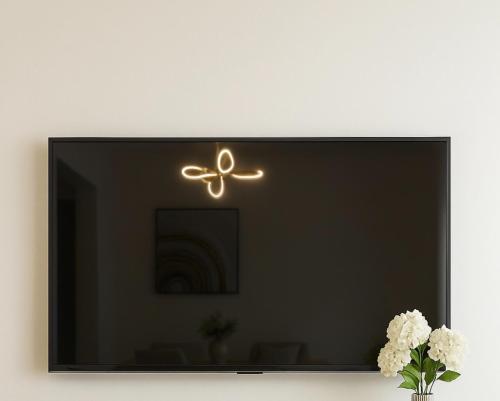 a flat screen tv sitting on top of a wall at Modern and fully equipped house in Samaná in Santa Bárbara de Samaná