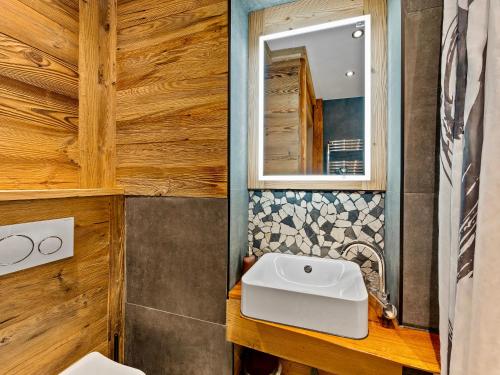 a bathroom with a sink and a mirror at Beautiful studio - private garden, EV, breakfast - Chalet Hug studio in Arzier