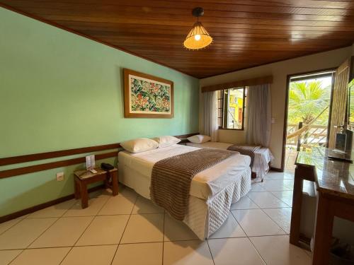 a bedroom with a large bed in a room at Hotel Mar de Cabo Frio in Cabo Frio