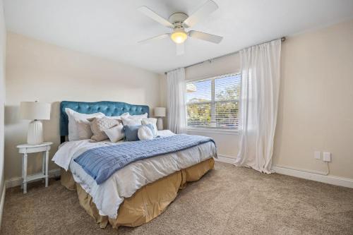 a bedroom with a bed and a ceiling fan at Beachside Blast Off Stylish Cape Canaveral Townhome Near Surf & Space in Cape Canaveral