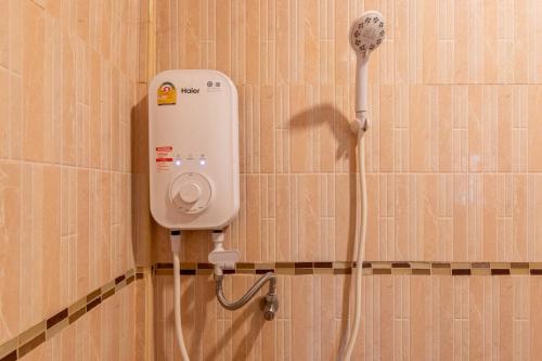 a bathroom with a hair dryer on a wall at Thailand Laos Border Superior Room in Ban Na Ko