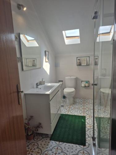 a bathroom with a sink and a toilet and a shower at Blue Castle House in Gouveia