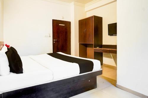 Ένα ή περισσότερα κρεβάτια σε δωμάτιο στο Super Collection O Maninagar Formerly Park Land